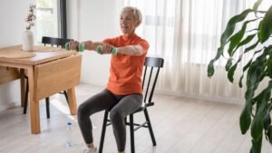 senior using chair support for clock reach balance training exercise