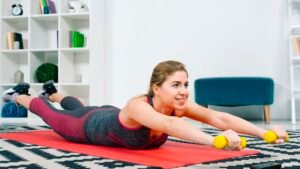 woman performing a women's full body workout with dumbbells at home