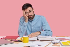 student sitting on desk with documents