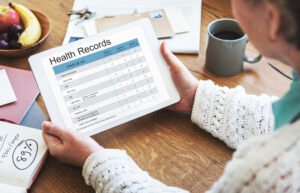 Adult recording weekly weight and activity on a simple health tracker