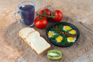 High protein breakfast with eggs, vegetables and whole grain toast